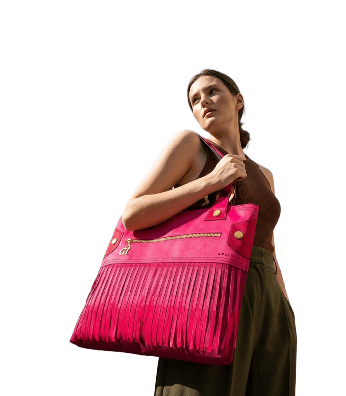 A woman wears a brown sleeveless top and olive green pants, carrying the Zip at Heart in front of Benaki Museum.